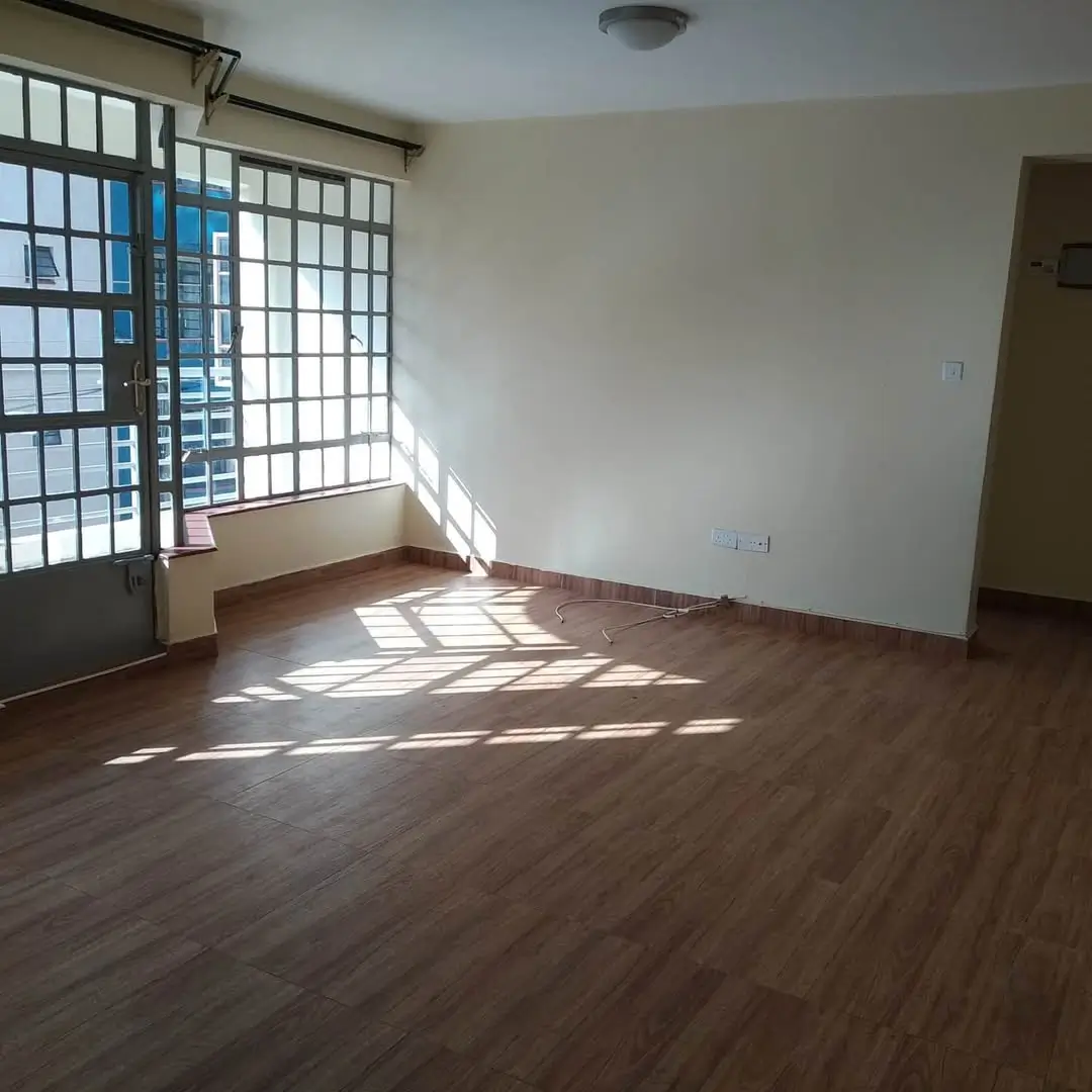 Spacious living room with wooden floors and grid windows