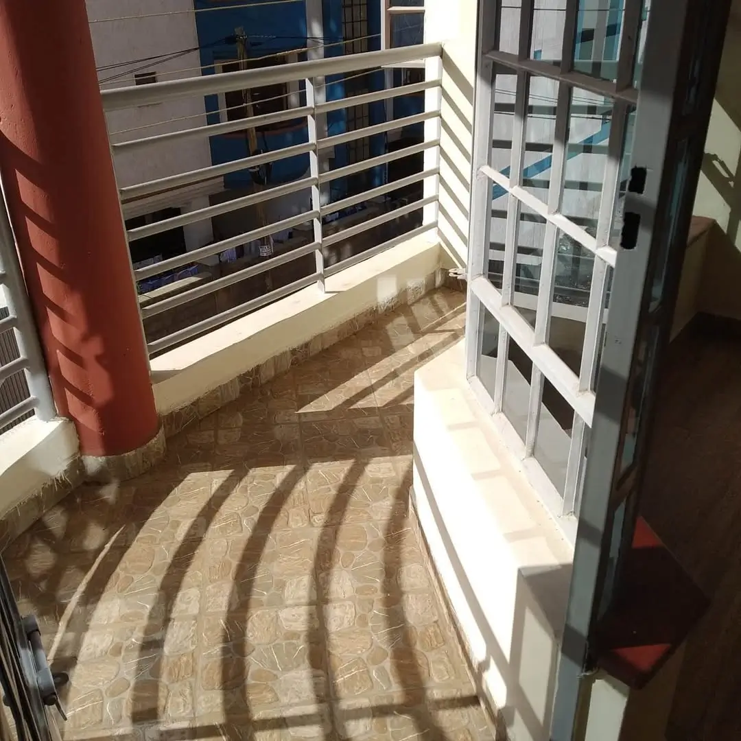 Spacious balcony with metal railings and city views