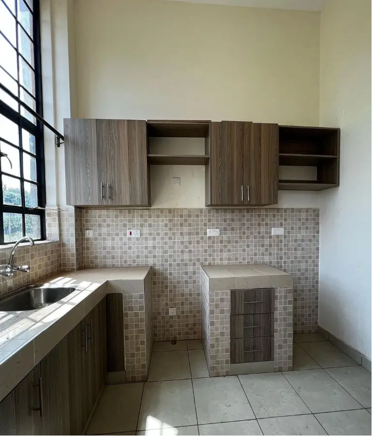Compact kitchen with mosaic tile backsplash and wooden cabinets