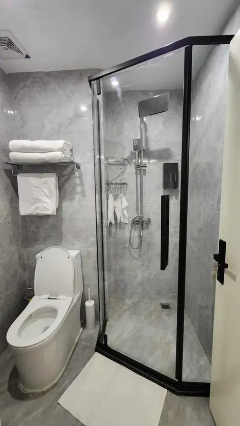 Modern bathroom with glass shower enclosure and smart toilet