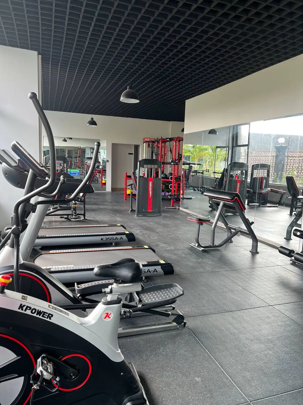 Modern gym with cardio equipment, weights, and training stations