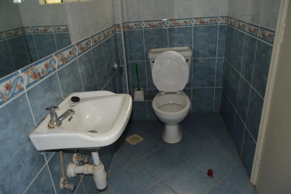 Compact bathroom with wall-mounted sink and toilet
