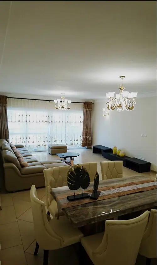 Open-plan living room with dining area and city views