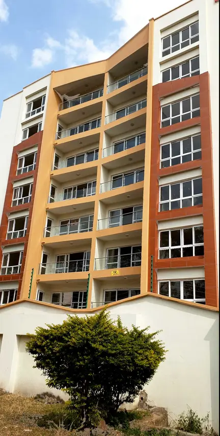 Modern residential building facade with balconies and landscaping