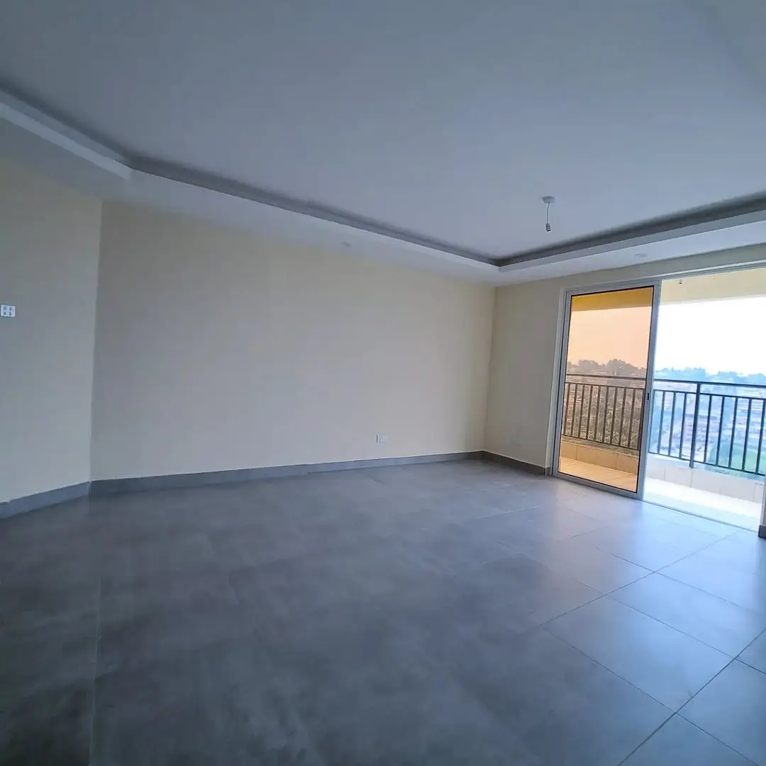 Spacious living room with balcony access and city views
