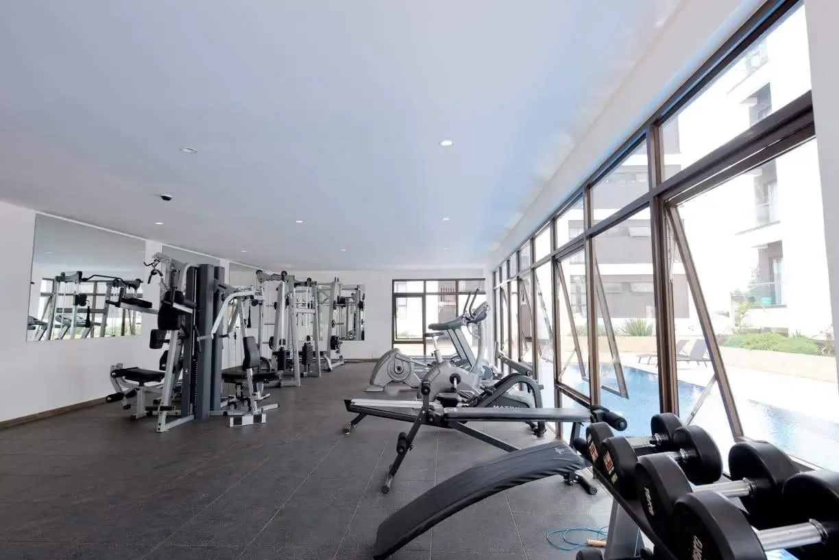 Spacious gym with cardio equipment and wall-mounted machines