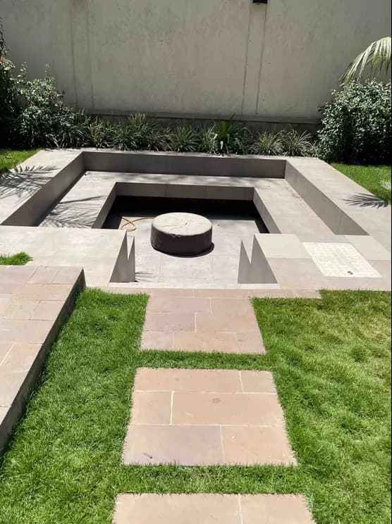 Modern landscaped garden with sunken seating area and firepit
