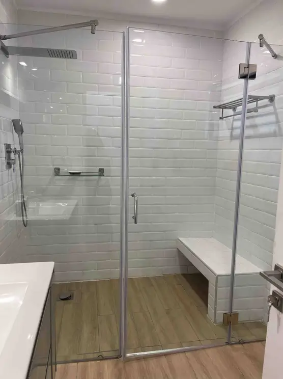 Modern walk-in shower with subway tile and glass enclosure