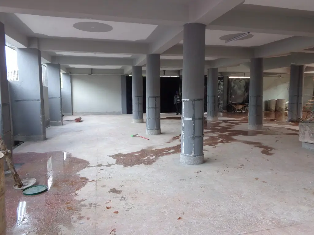 Large open basement or ground floor lobby with support columns