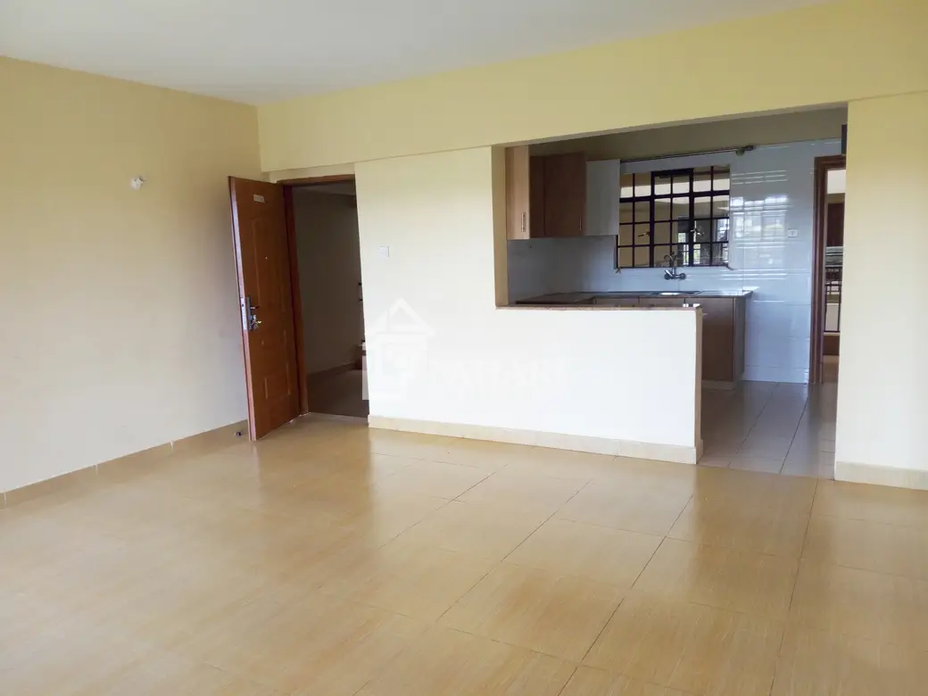 Open-plan living room with adjoining kitchen counter visible