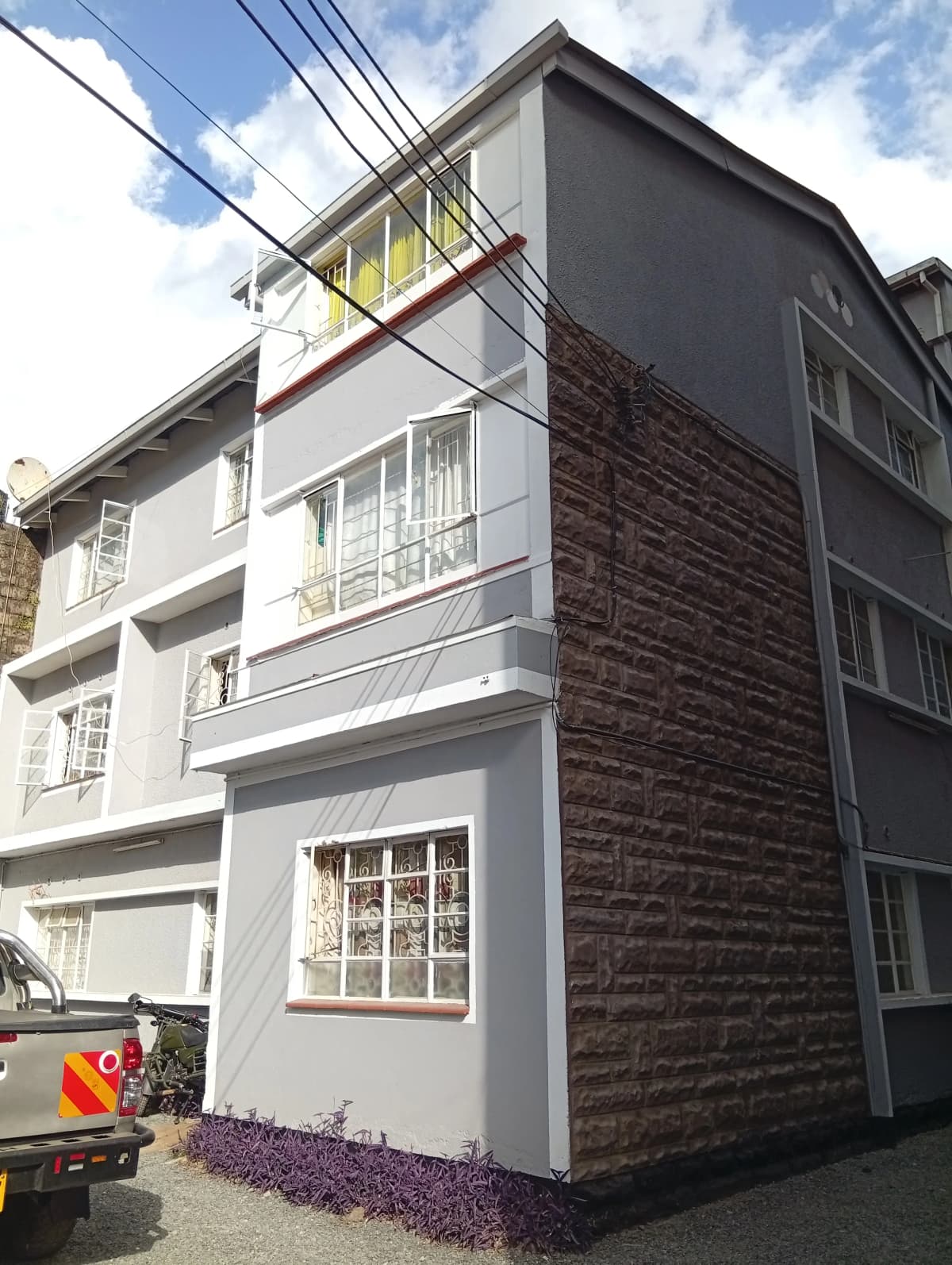 Modern multi-story residential building with mixed finishes