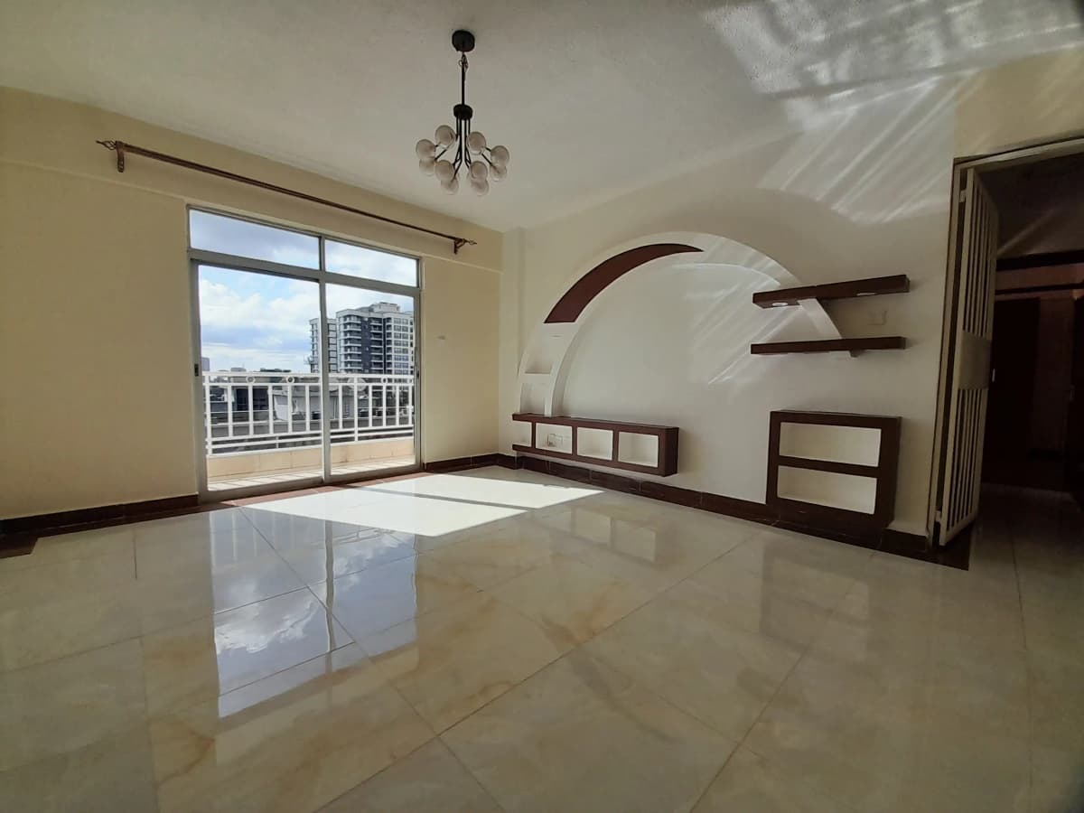 Spacious living room with curved feature wall and balcony access