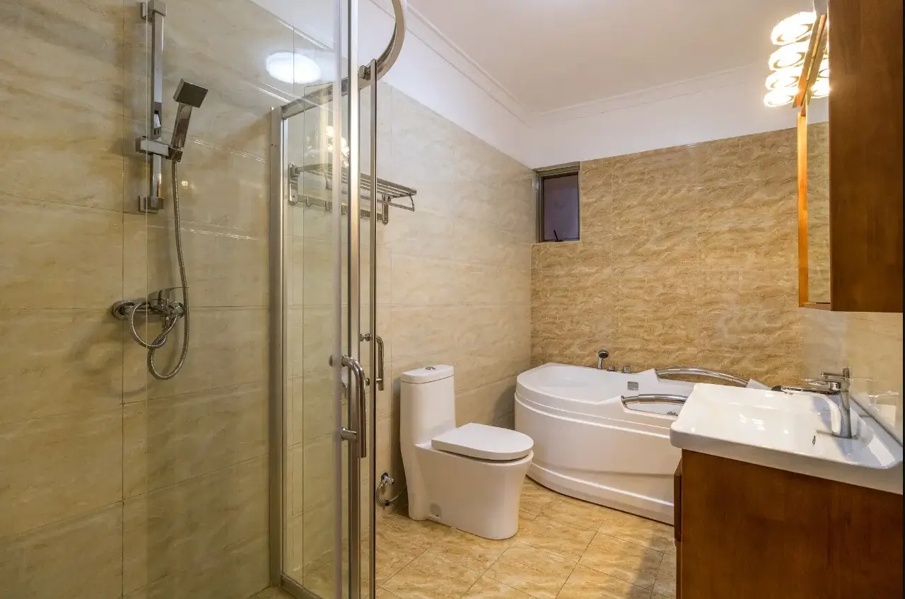 Spacious bathroom with walk-in shower, bathtub, and vanity