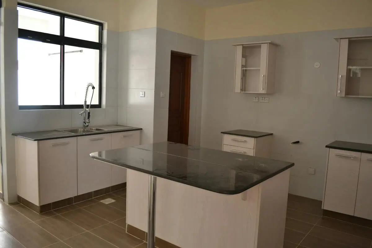 Modern kitchen with island counter and black countertops