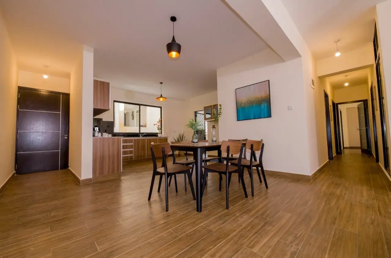 Open-plan dining area with kitchen visible in background