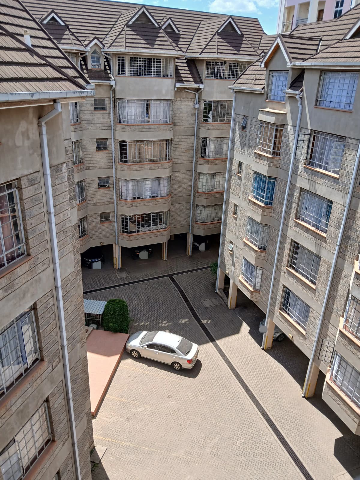 Residential compound parking area with apartment buildings