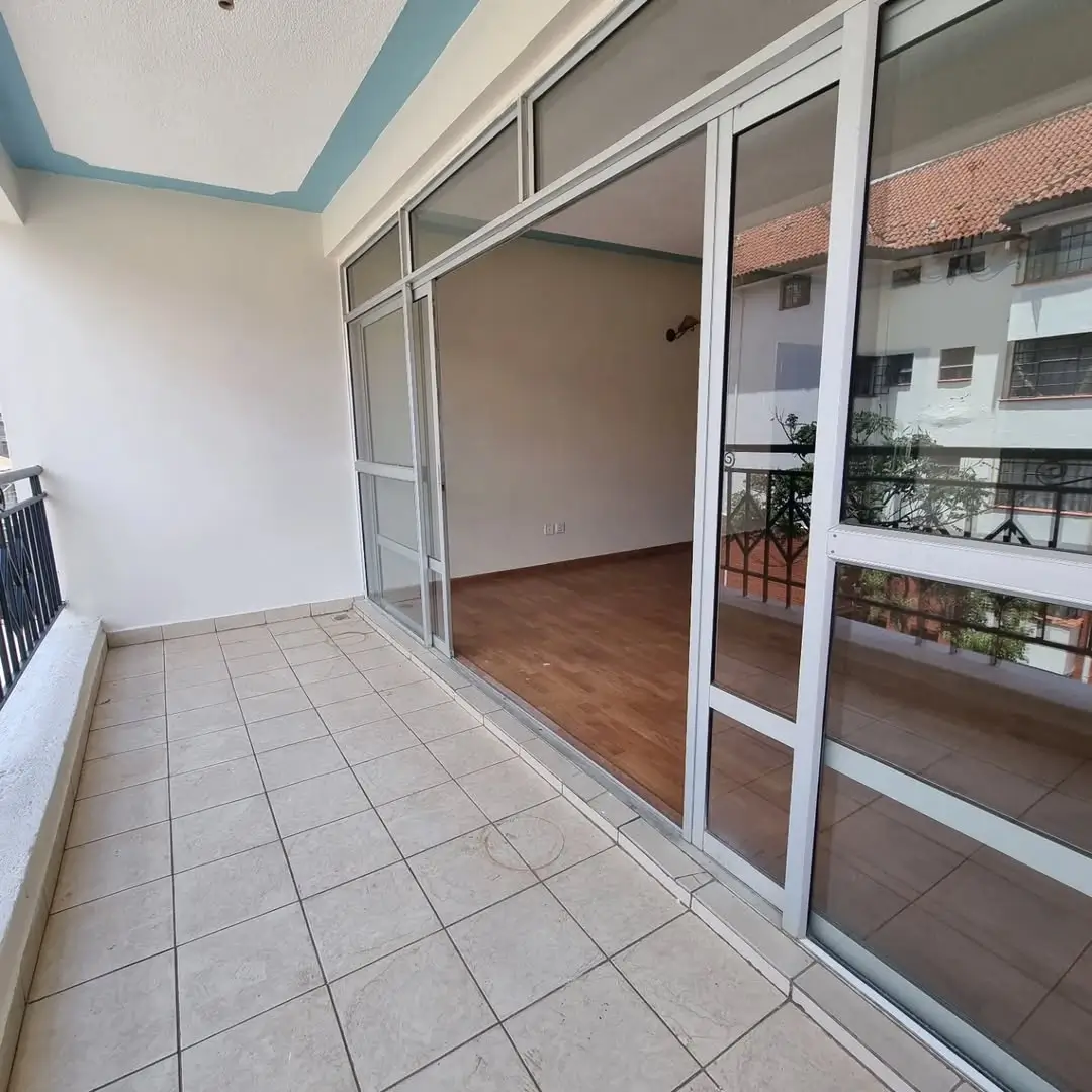 Spacious balcony with sliding glass doors and street views