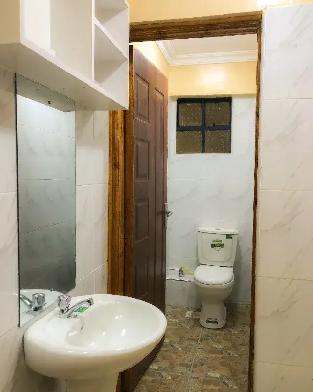 Compact bathroom with round sink and toilet