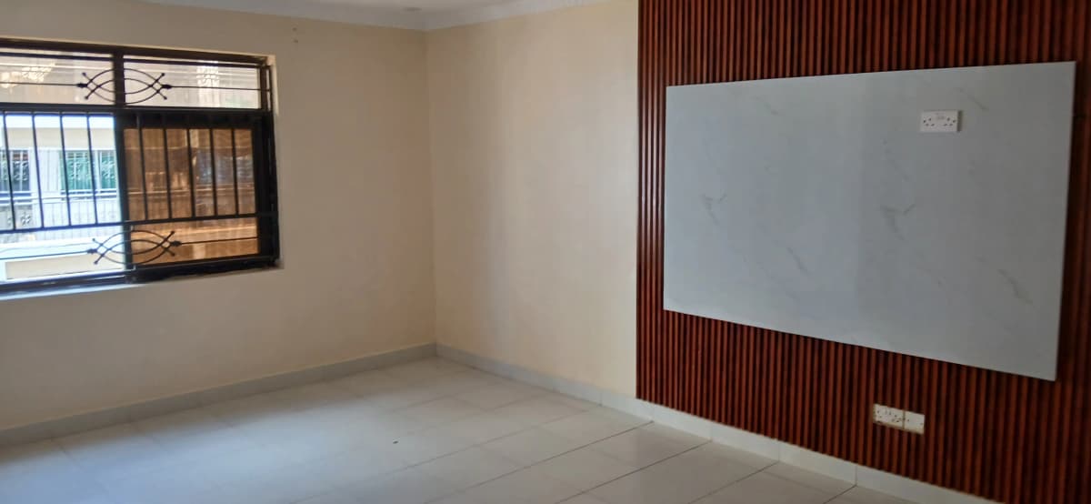 Empty living room with whiteboard wall feature and window