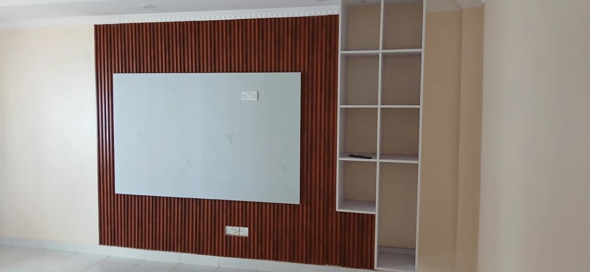 Modern living room with wall-mounted TV and wooden accent panel