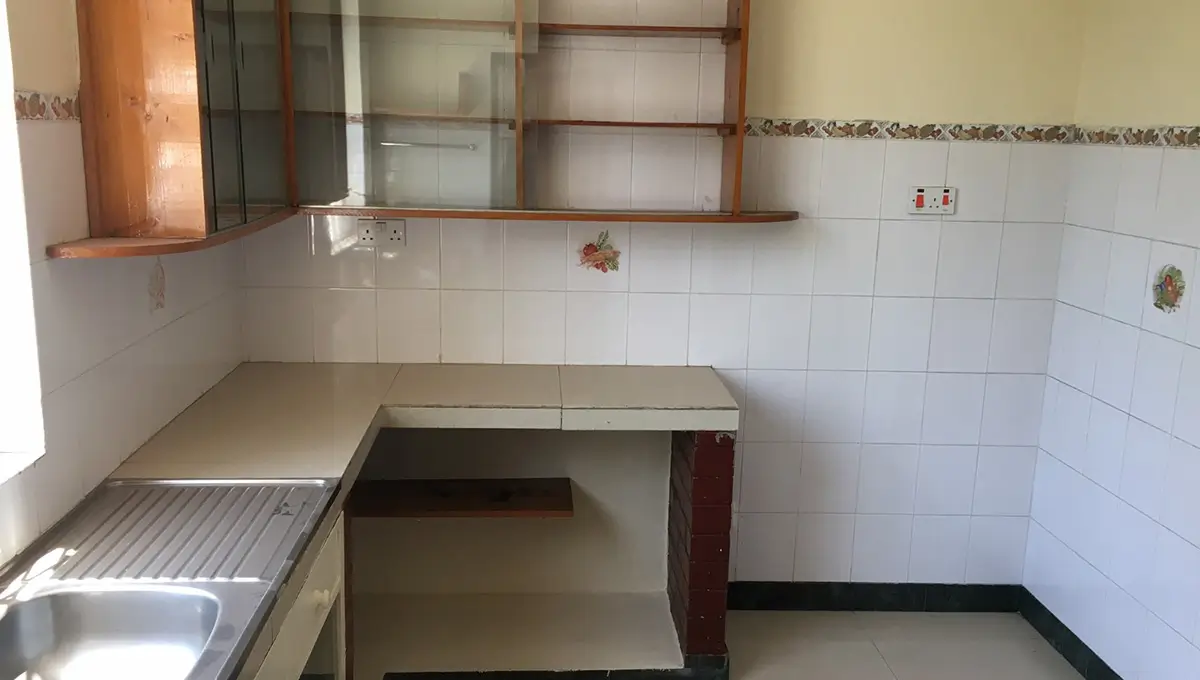 Compact kitchen with stainless steel sink and basic countertops