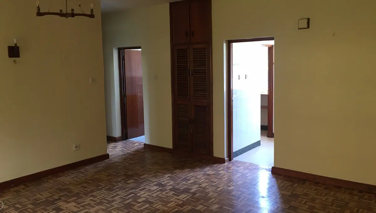Spacious empty living room with herringbone wood flooring