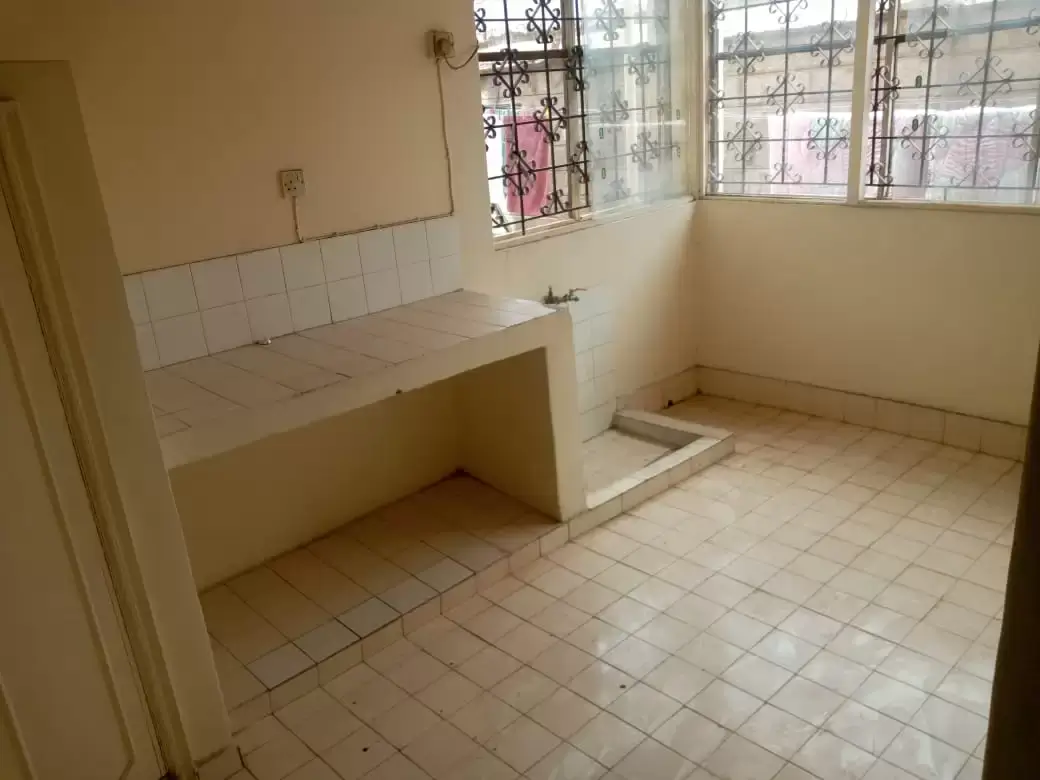 Basic kitchen with tile countertop and large window