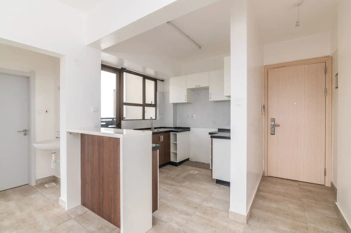 Open-plan kitchen with dark wood cabinetry and breakfast counter