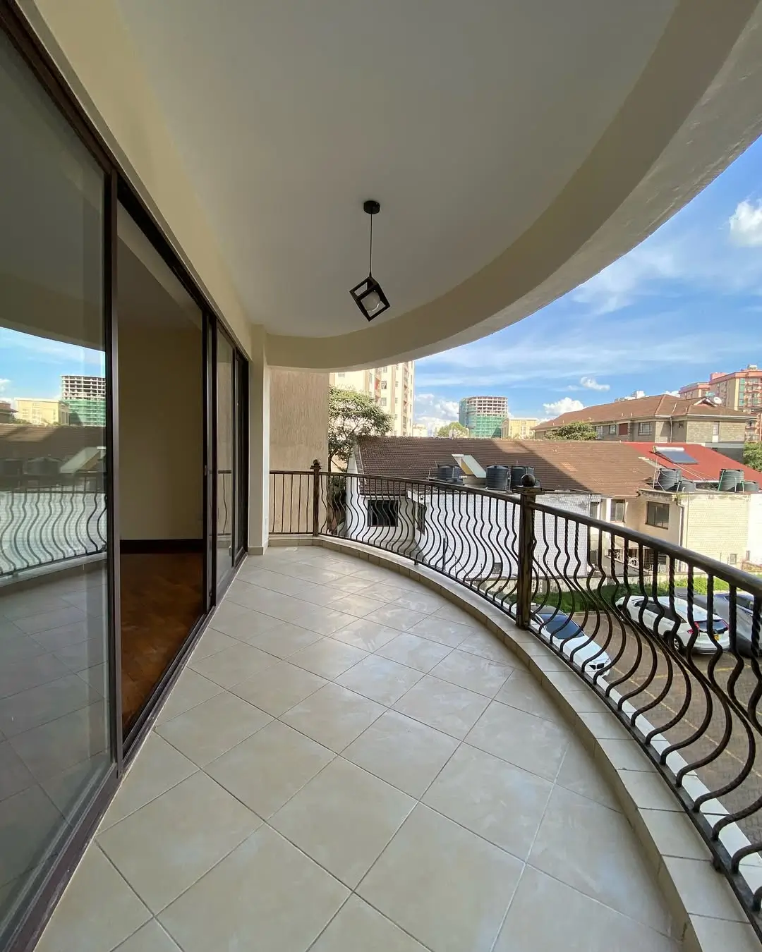 Curved balcony with city skyline views and modern railing