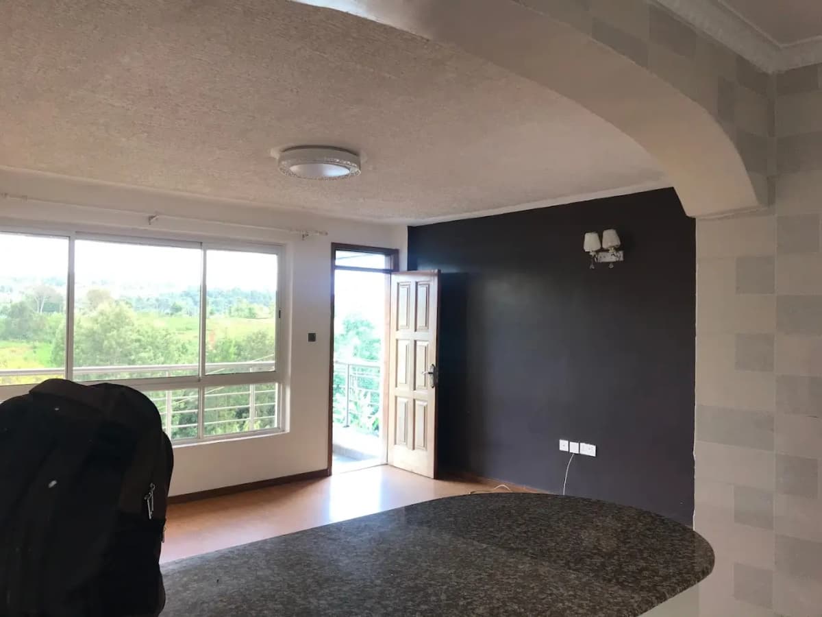 Spacious living room with panoramic windows overlooking green landscape