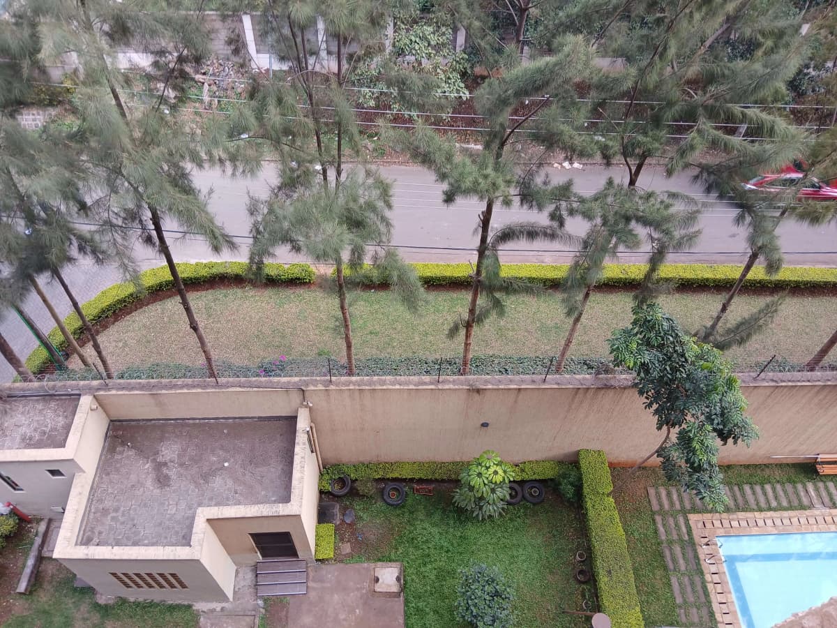Aerial view of compound grounds with manicured lawn and pool