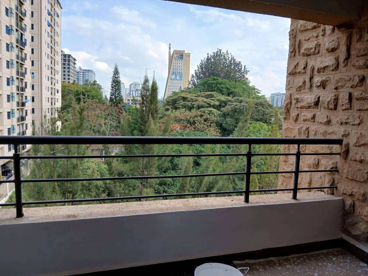 Elevated balcony with city skyline and green landscape views