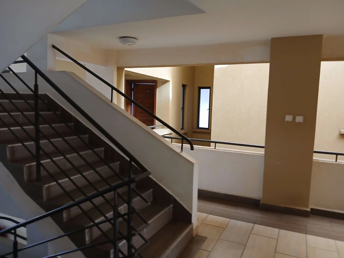 Multi-level lobby with staircase and modern railings