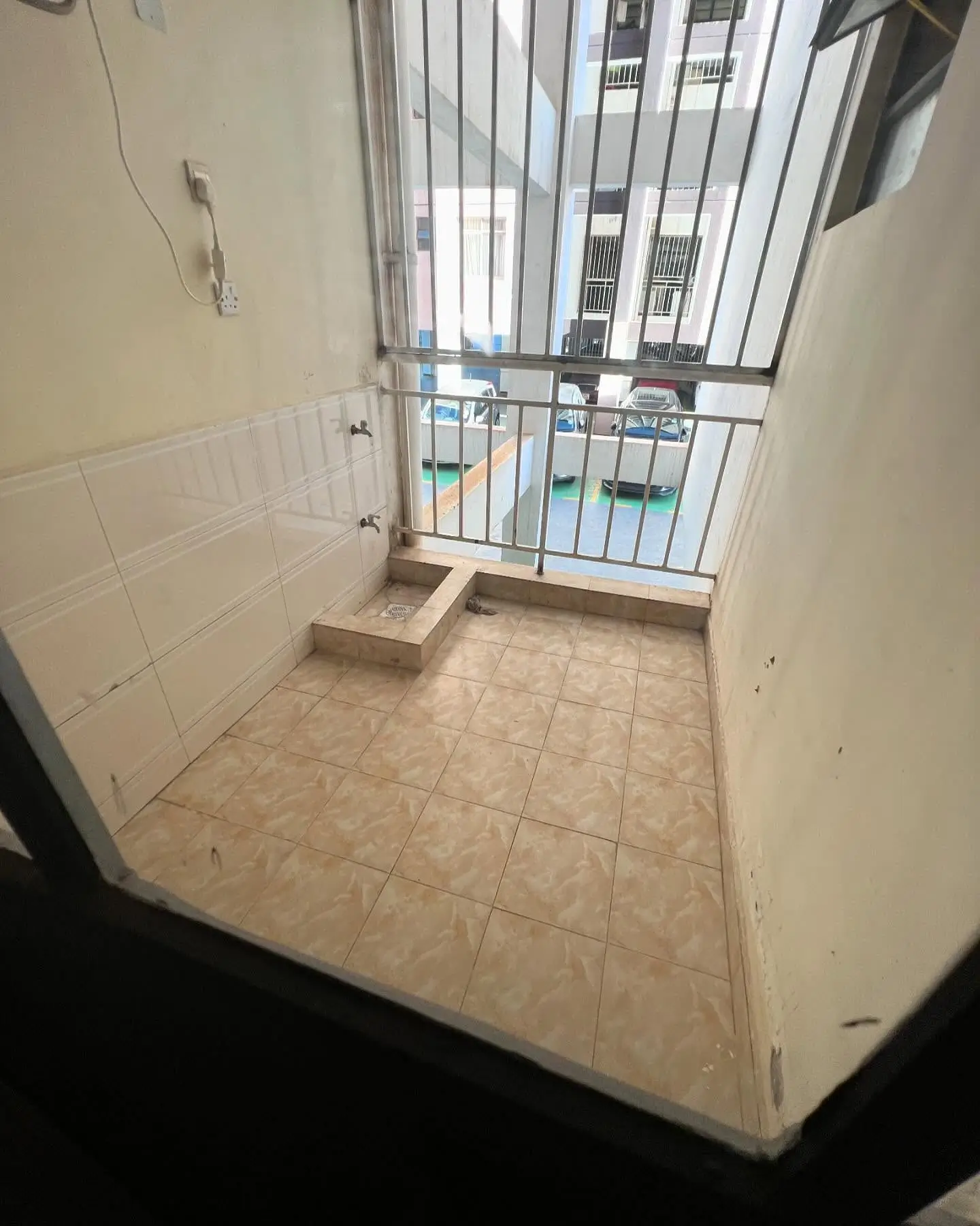 Compact balcony with metal railing and tiled flooring