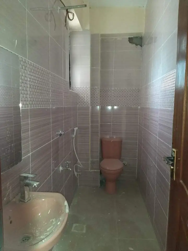 Modern bathroom with shower enclosure, sink, and toilet