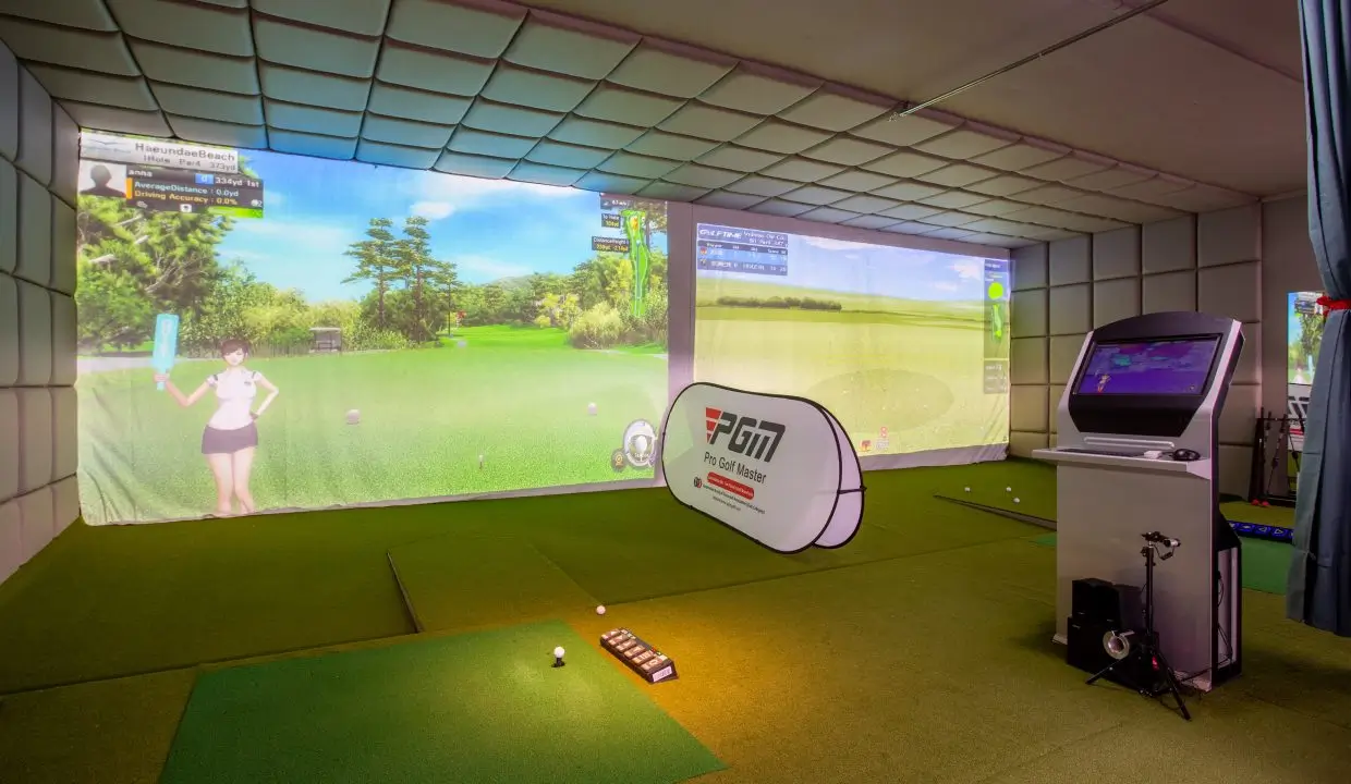 Indoor golf simulator room with interactive screens and equipment