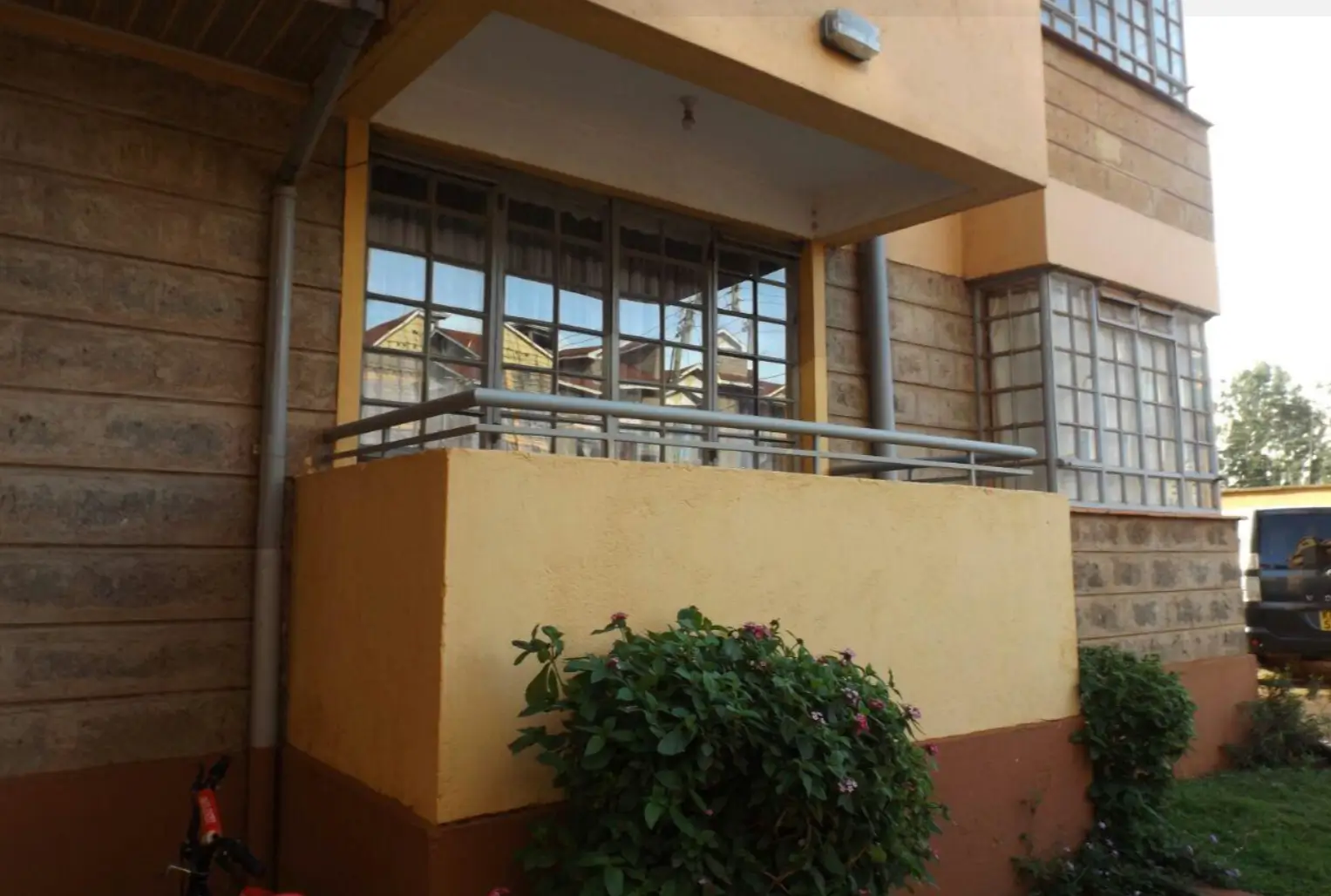 Modern residential facade with balcony and large windows