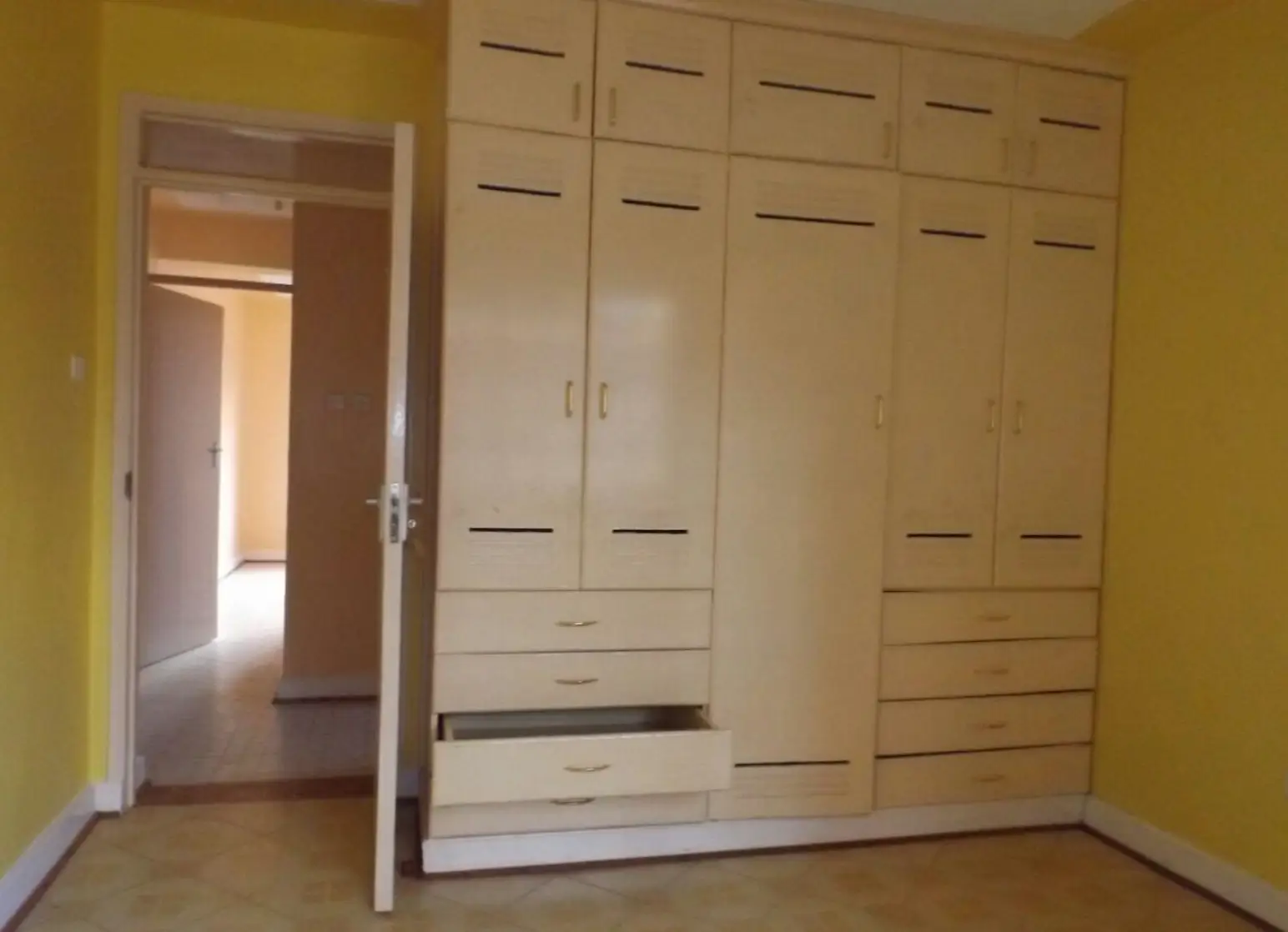 Bedroom with built-in wardrobe and yellow walls
