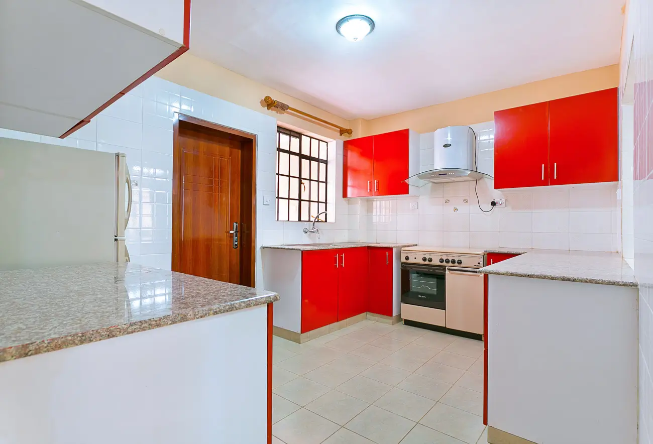 Modern kitchen with red cabinetry, granite countertop, stainless steel appliances