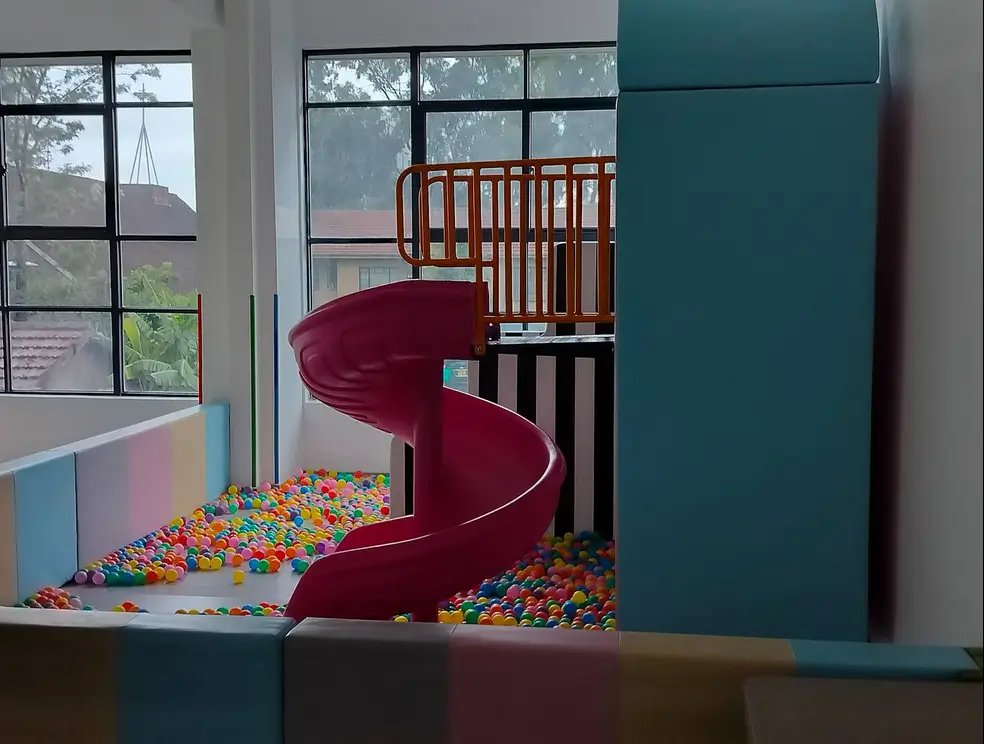 Children's bedroom with ball pit play area and wooden crib