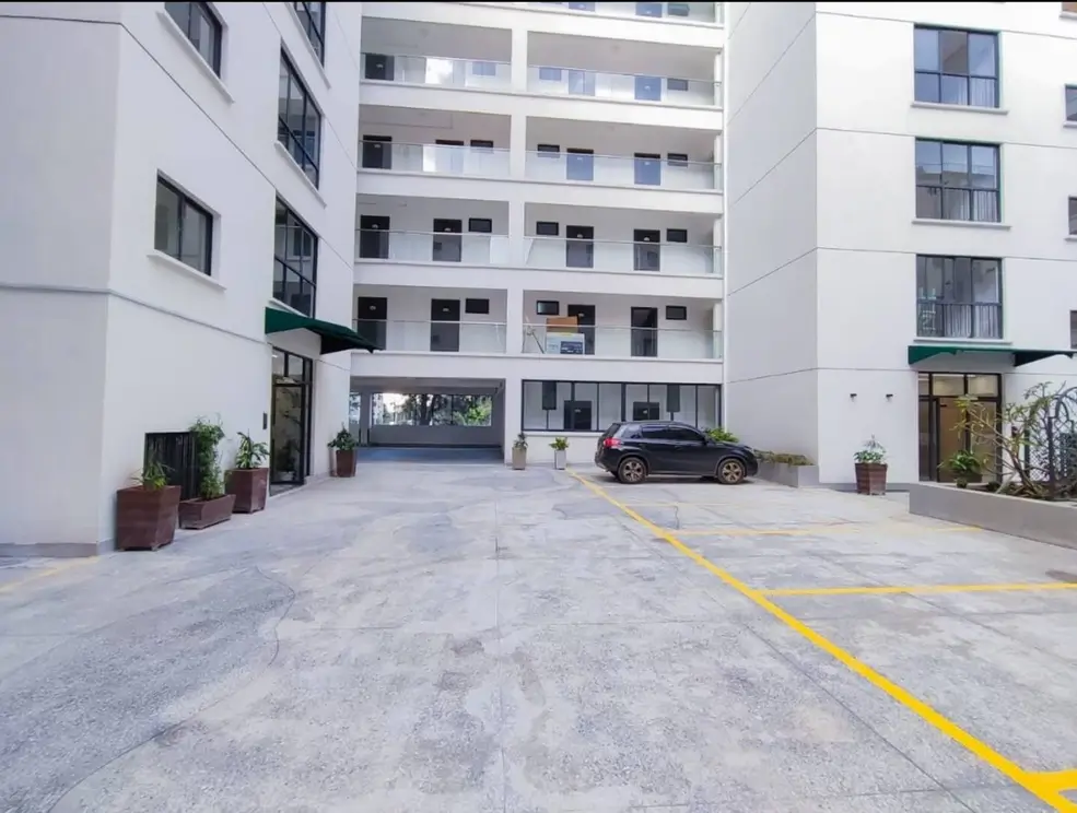 Secure compound parking area with marked bays and building entrance