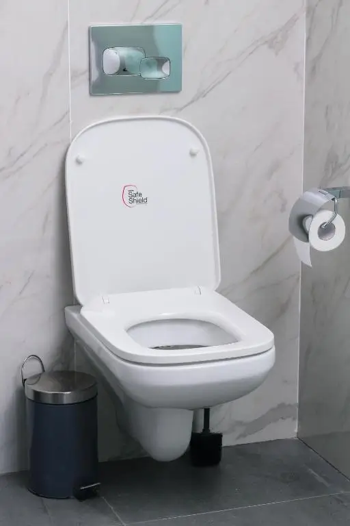 Modern wall-mounted toilet with marble tile surroundings