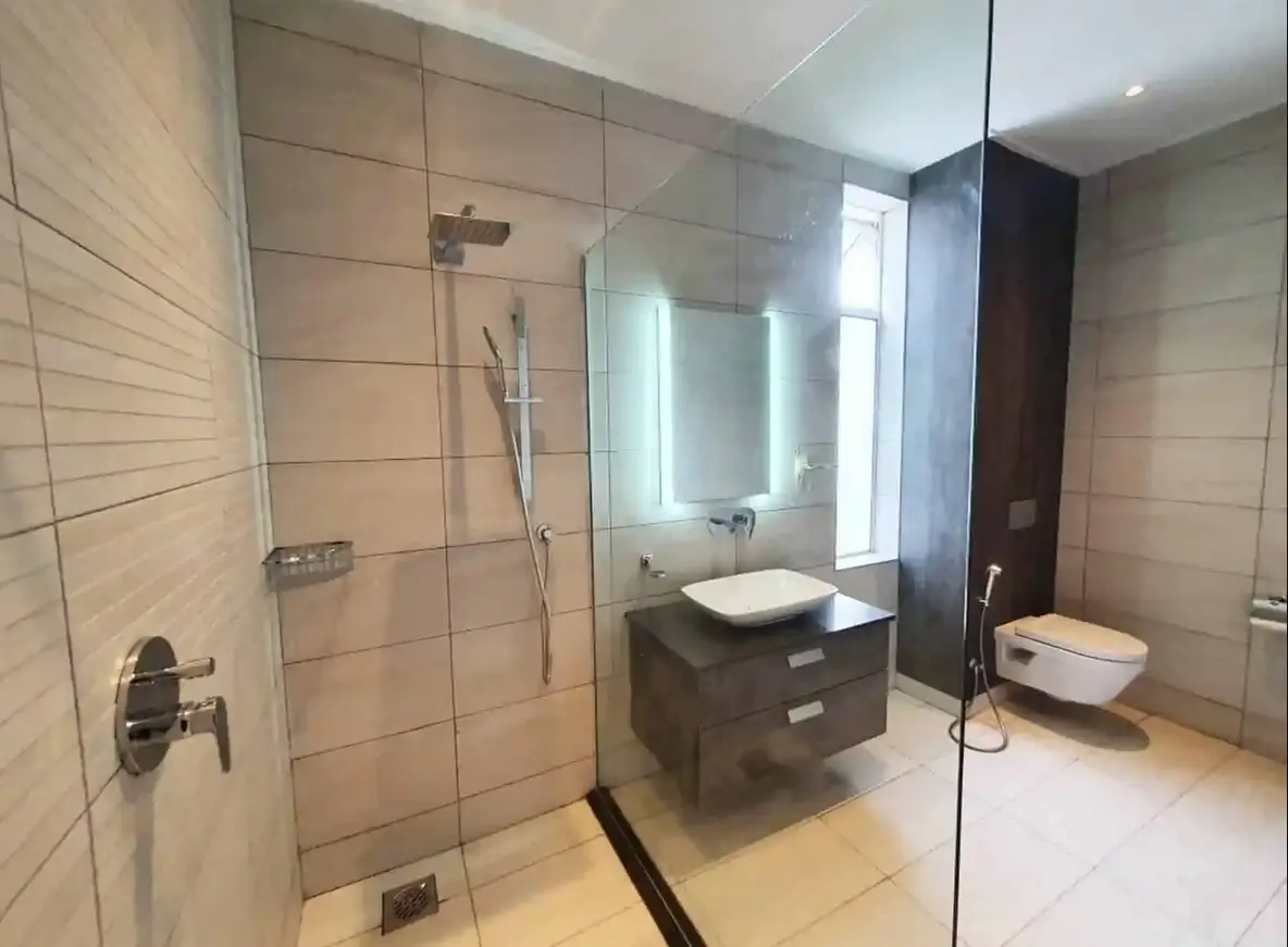 Modern bathroom with walk-in shower, floating vanity, dual mirrors