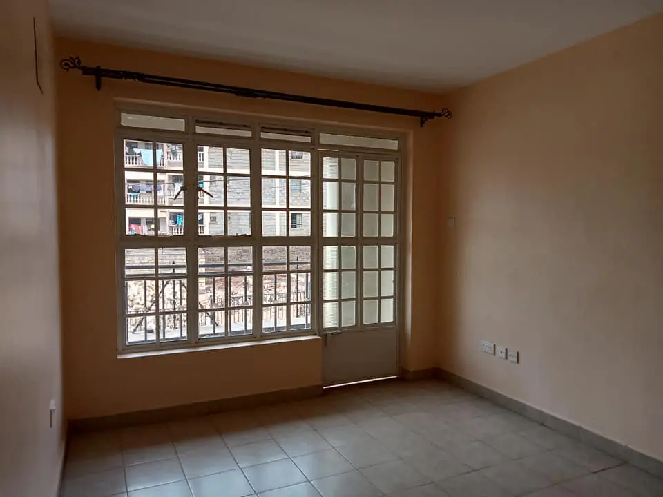 Interior room with large windows overlooking urban street below