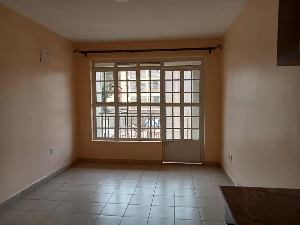 Bright living room with large glazed door and windows