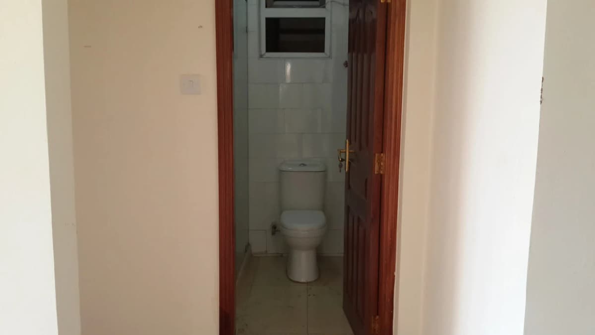 Compact bathroom with toilet and wall-mounted fixtures