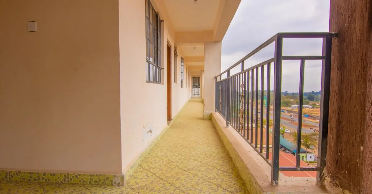 Long covered balcony with city views and metal railings