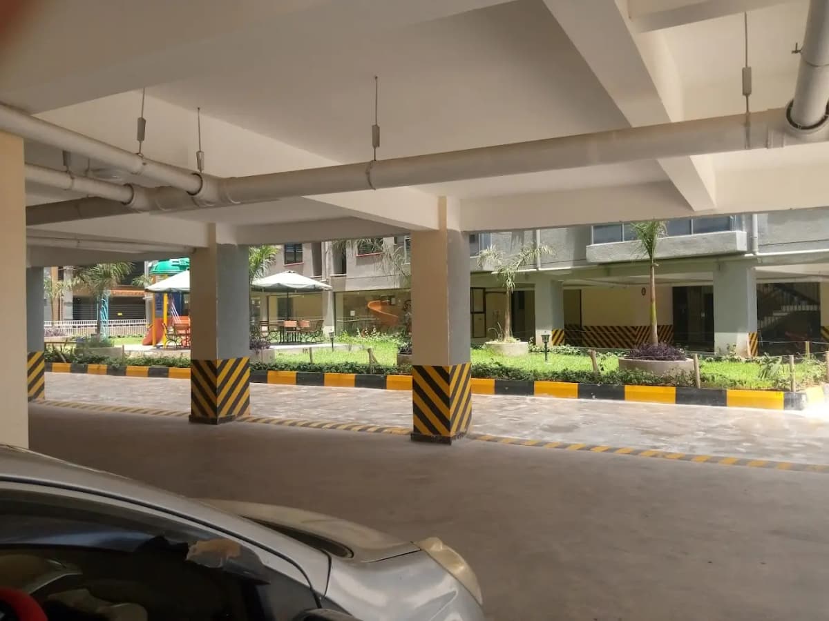 Underground parking structure with concrete pillars and yellow safety markings