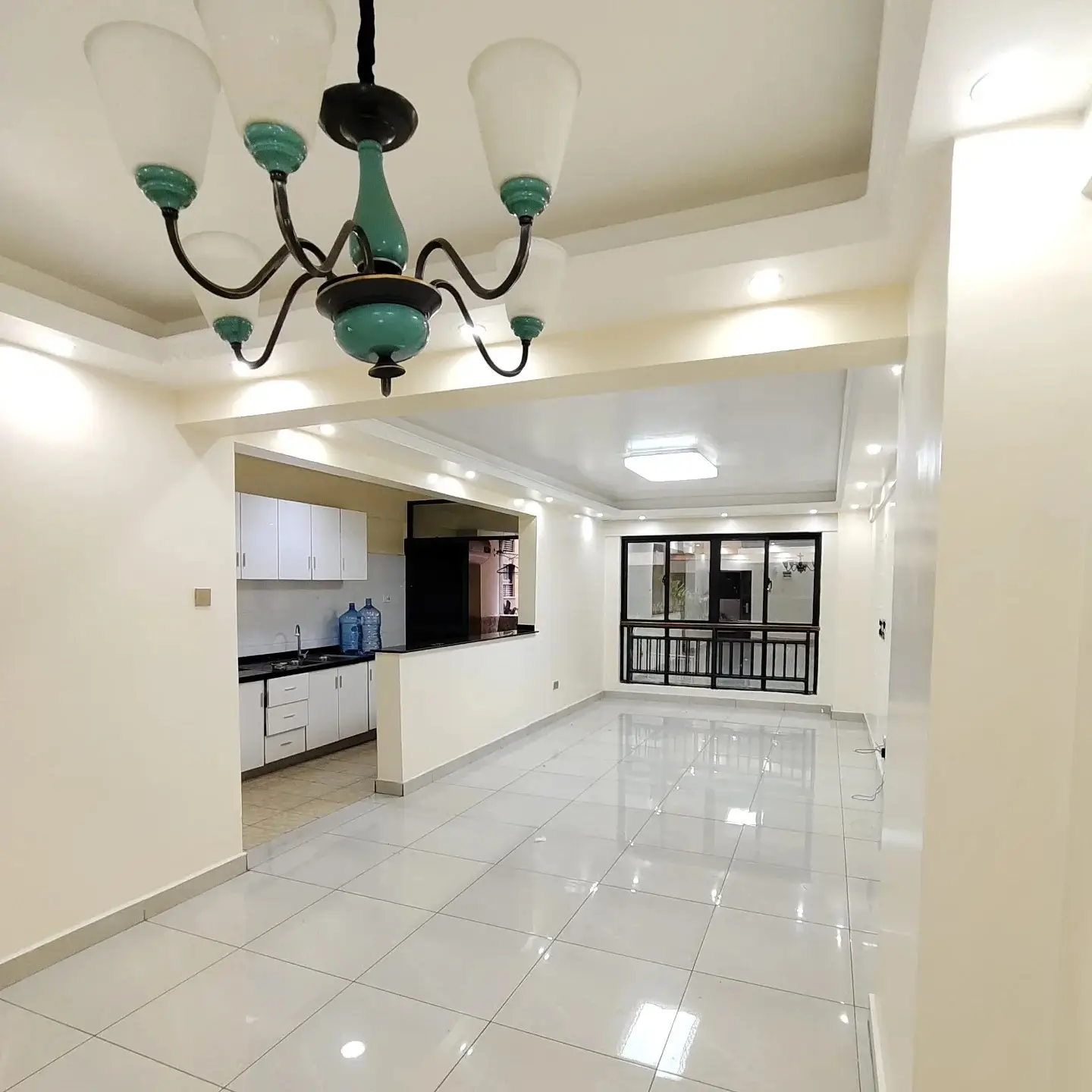 Open-plan living and kitchen with polished tile flooring