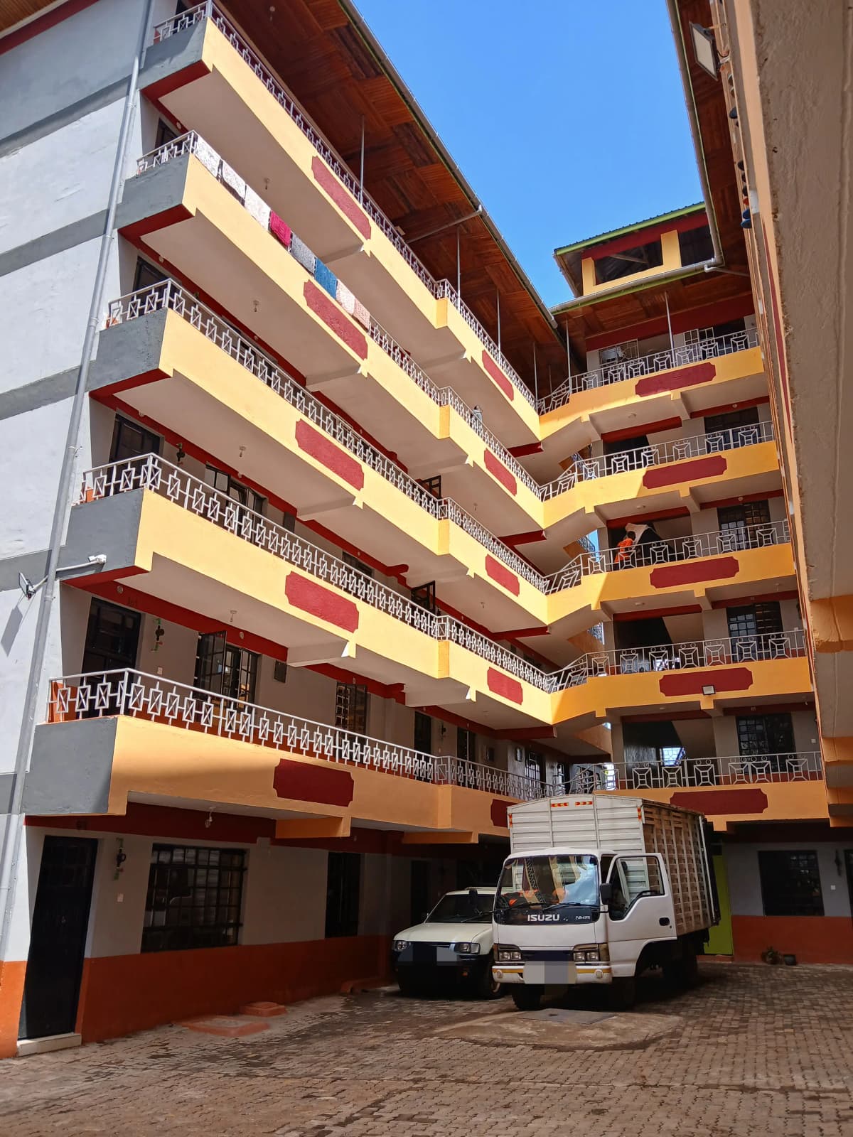 Multi-story residential building with colored facade and balconies